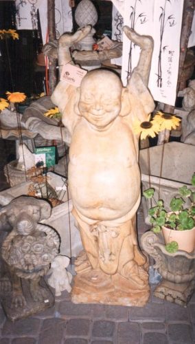 A large Happy Buddha welcomes customers.